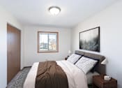 Thumbnail 3 of 13 - a bedroom with a bed and a window. Fargo, ND Hartford Apartments