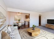 Thumbnail 1 of 13 - a living room with a couch and a table and a tv. Fargo, ND Hartford Apartments