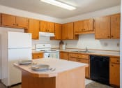 Thumbnail 7 of 13 - a kitchen with white appliances and wooden cabinets. Fargo, ND Hunters Run 2 Apartments
