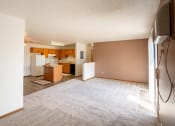 Thumbnail 5 of 13 - an empty living room with a kitchen in the background. Fargo, ND Hunters Run 2 Apartments