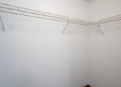 Thumbnail 12 of 14 - a large walk in closet with white walls. Fargo, ND Kentwood Manor Apartments