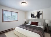 Thumbnail 3 of 14 - a bedroom with a large bed and a window. Fargo, ND Kentwood Manor Apartments