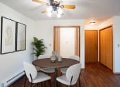 Thumbnail 2 of 14 - a dining room with a table and chairs and a ceiling fan. Fargo, ND Kentwood Manor Apartments