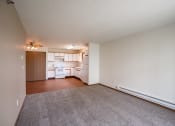 Thumbnail 18 of 49 - an empty living room with a kitchen in the background.West Fargo, ND Lake Crest Apartments 21e