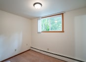 Thumbnail 7 of 11 - an empty room with a window and white walls. Fargo, ND Luxford Apartments