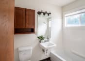 Thumbnail 5 of 11 - a bathroom with a sink and a toilet and a bath tub. Fargo, ND Luxford Apartments