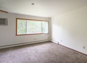 Thumbnail 3 of 11 - an empty room with carpet and a window. Fargo, ND Luxford Apartments