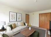 Thumbnail 1 of 11 - a living room with a couch and a coffee table. Fargo, ND Luxford Apartments