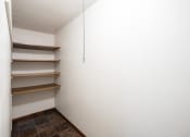 Thumbnail 19 of 20 - a room with white walls and shelves on the wall. Fargo, ND Martha Alice Apartments