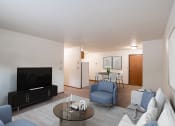 Thumbnail 2 of 26 - a living room with a couch and a table and a tv. Fargo, ND Monticello Apartments