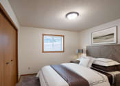Thumbnail 3 of 26 - a bedroom with a bed and a closet. Fargo, ND Monticello Apartments
