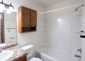 Thumbnail 19 of 26 - a bathroom with a sink and a toilet and a bath tub. Fargo, ND Monticello Apartments