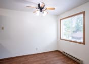 Thumbnail 14 of 26 - an empty room with a ceiling fan and a window. Fargo, ND Monticello Apartments