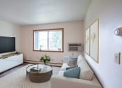 Thumbnail 1 of 15 - a living room with a couch and a coffee table and a television. Fargo ND Morningside Apartments