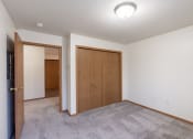 Thumbnail 25 of 31 - an empty living room with a door to a bedroom and a closet. Fargo, ND Oxford Apartments