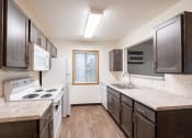 Thumbnail 22 of 31 - an apartment kitchen with white appliances. Fargo, ND Oxford Apartments
