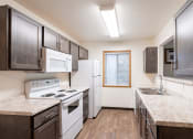 Thumbnail 21 of 31 - an apartment kitchen with white appliances. Fargo, ND Oxford Apartments