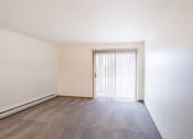 Thumbnail 19 of 31 - the spacious living room of an apartment with a door to the balcony. Fargo, ND Oxford Apartments