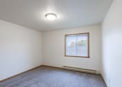 Thumbnail 12 of 31 - the living room of an empty house with a window. Fargo, ND Oxford Apartments