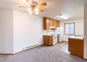 Thumbnail 10 of 31 - a dining room with a kitchen and a ceiling fan. Fargo, ND Oxford Apartments