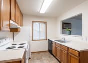Thumbnail 11 of 31 - a kitchen with a stove sink and a refrigerator. Fargo, ND Oxford Apartments