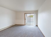 Thumbnail 30 of 31 - a living room with a glass sliding door. Fargo, ND Oxford Apartments