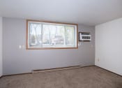 Thumbnail 22 of 28 - an empty living room with a window and a microwave. Fargo, ND Pacific Park 2