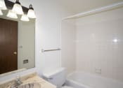 Thumbnail 14 of 28 - a white bathroom with a tub and a sink and a mirror. Fargo, ND Pacific Park 2