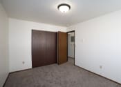 Thumbnail 11 of 28 - a bedroom with a closet and a door to a hallway. Fargo, ND Pacific Park 2
