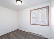 Thumbnail 12 of 28 - an empty room with a large window and carpet. Fargo, ND Pacific Park 2