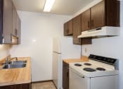 Thumbnail 9 of 28 - an empty kitchen with a stove refrigerator and sink. Fargo, ND Pacific Park 2