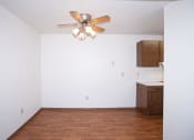 Thumbnail 7 of 22 - a dining room with a ceiling fan and a kitchen. Fargo, ND Pacific Park Apartments