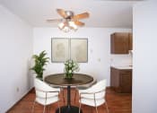 Thumbnail 5 of 22 - a dining room with a table and chairs and a ceiling fan. Fargo, ND Pacific Park Apartments