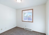 Thumbnail 19 of 22 - the living room of an empty house with a window. Fargo, ND Pacific Park Apartments