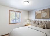 Thumbnail 3 of 22 - a bedroom with a large bed and a window. Fargo, ND Pacific Park Apartments