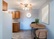 Thumbnail 2 of 22 - a dining room with a table and a clock on the wall. Fargo, ND Pacific Park Apartments