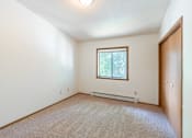 Thumbnail 12 of 19 - the living room of an empty house with a window. Fargo, ND Rosegate Apartments