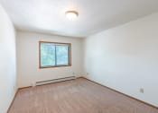 Thumbnail 11 of 19 - the living room of an empty house with a window. Fargo, ND Rosegate Apartments