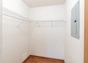 Thumbnail 15 of 19 - an empty closet with a metal rack on the wall and a wood floor. Fargo, ND Rosegate Apartments