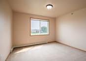 Thumbnail 52 of 61 - the spacious living room has a large window and beige carpet