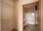Thumbnail 54 of 61 - a bathroom with a closet and a toilet and a bath tub. West Fargo, ND West Lake Apartments 11A