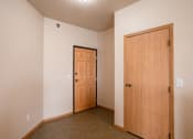 Thumbnail 55 of 61 - an empty room with a door and a closet. West Fargo, ND West Lake Apartments 11A