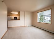 Thumbnail 49 of 61 - the living room of an empty apartment with a large window. West Fargo, ND West Lake Apartments