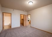 Thumbnail 34 of 61 - a bedroom with a walk in closet and a bathroom. Fargo, ND West Lake Apartments