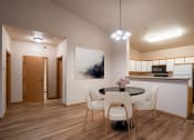 Thumbnail 2 of 61 - a dining room with a table and chairs and a kitchen. Fargo, ND West Lake Apartments