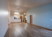 Thumbnail 39 of 61 - the living room and dining area of an empty apartment with wood floors and blue walls. Fargo, ND West Lake Apartments