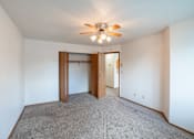 Thumbnail 21 of 25 - a bedroom with a closet and ceiling fan. Fargo, ND Westview Towers Apartments | Bedroom