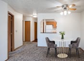Thumbnail 6 of 25 - our living room and dining room with a white table and chairs and a ceiling fan. Fargo, ND Westview Towers Apartments