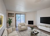 Thumbnail 5 of 25 - a living room with a couch and a television
