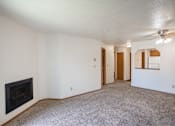 Thumbnail 18 of 25 - an empty living room with a fireplace and a ceiling fan. Fargo, ND Westview Towers Apartments